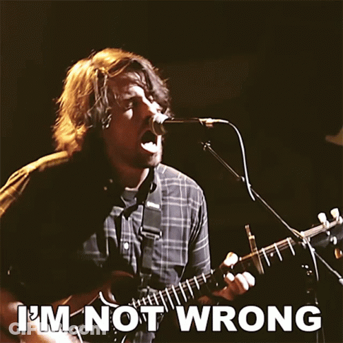 A Man Singing Into A Microphone While Playing A Guitar With The Words " I 'M Not Wrong " Above Him GIF