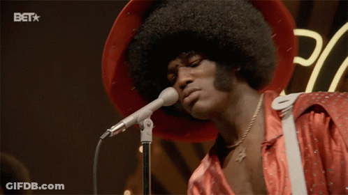 A Man Singing Into A Microphone With A Bet Logo In The Corner GIF