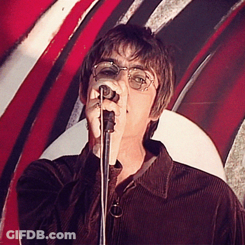A Man Singing Into A Microphone With A Red White And Black Background GIF