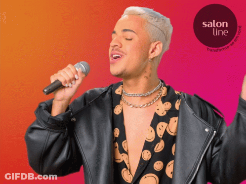 A Man Singing Into A Microphone With A Salon Line Logo In The Corner GIF