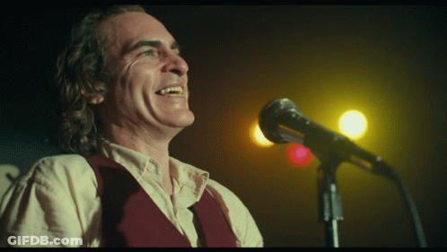 Man Singing Into Microphone With Smiley Face GIF
