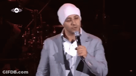 A Man Singing Into A Microphone With An Arrow Pointing To The Left GIF