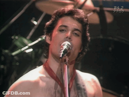 A Man Singing Into A Microphone With Bs 2 Written On The Bottom Right GIF
