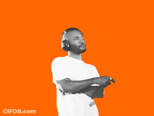 A Man Singing Into A Microphone With Headphones On GIF