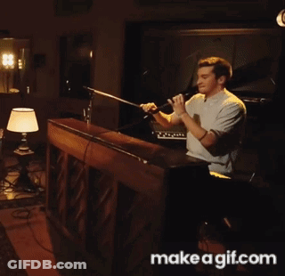 A Man Singing Into A Microphone With Make A Gif.com Written On The Bottom GIF