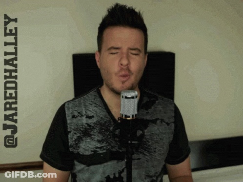 A Man Singing Into A Microphone With The Name Jaredhalley Written Above Him GIF