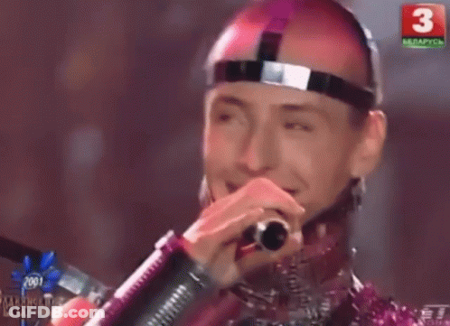 A Man Singing Into A Microphone With The Number 3 On The Bottom Right GIF