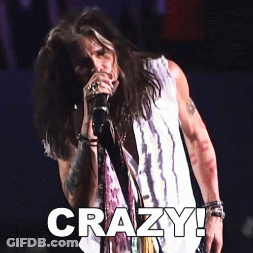 A Man Singing Into A Microphone With The Word Crazy Written Below Him GIF