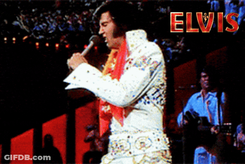 A Man Singing Into A Microphone With The Word Elvis In Red GIF