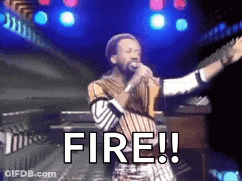 A Man Singing Into A Microphone With The Word Fire Written On It GIF