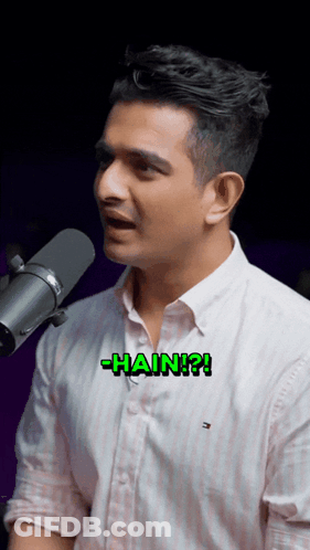 A Man Singing Into A Microphone With The Word Hain Written On His Chest GIF