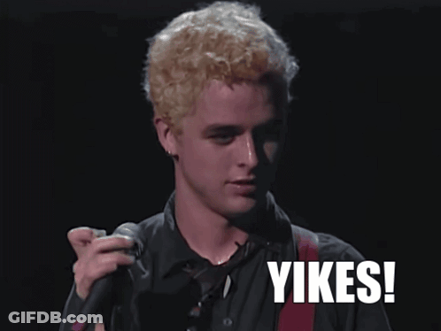 A Man Singing Into A Microphone With The Word Yikes On The Bottom Right GIF