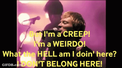 A Man Singing Into A Microphone With The Words But I 'M A Creep In Yellow GIF