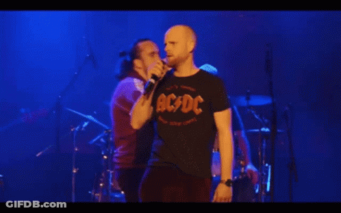 A Man Singing Into A Microphone With The Words C Mon Guys C Mon Above Him GIF