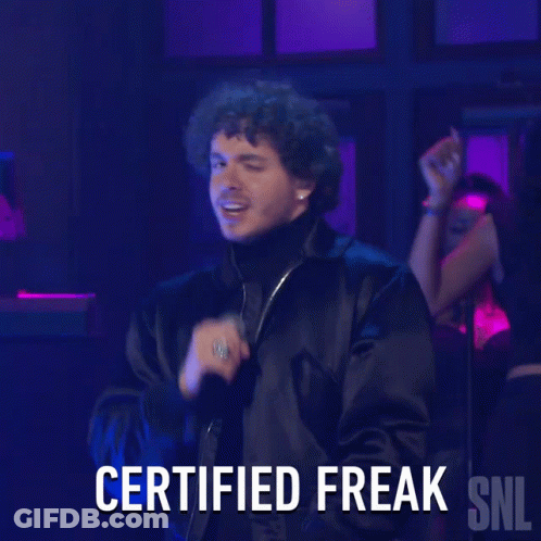 A Man Singing Into A Microphone With The Words Certified Freak Snl Below Him GIF