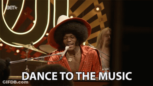 A Man Singing Into A Microphone With The Words Dance To The Music GIF
