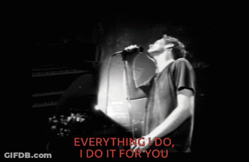 A Man Singing Into A Microphone With The Words Everything I Do I Do It For You Behind Him GIF