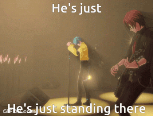 A Man Singing Into A Microphone With The Words He 'S Just He 'S Just Standing There On The Bottom GIF