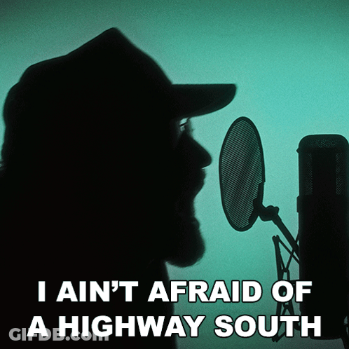 A Man Singing Into A Microphone With The Words " I Ain 'T Afraid Of A Highway South " Below Him GIF
