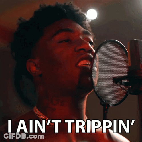 A Man Singing Into A Microphone With The Words " I Ain 'T Trippin ' " Below Him GIF