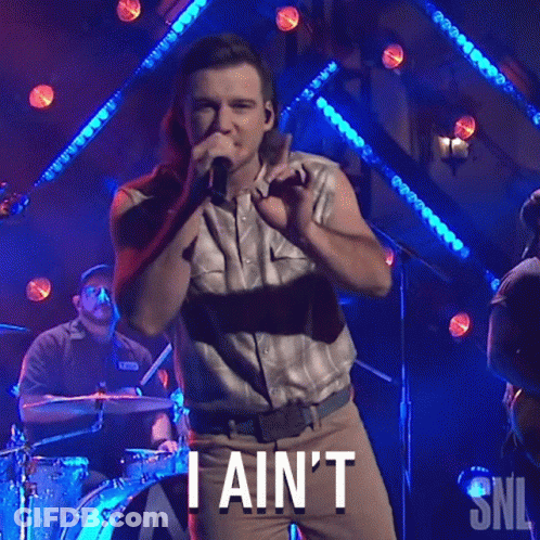 A Man Singing Into A Microphone With The Words " I Ain 'T " Written Below Him GIF