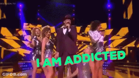 A Man Singing Into A Microphone With The Words " I Am Addicted " On The Bottom GIF
