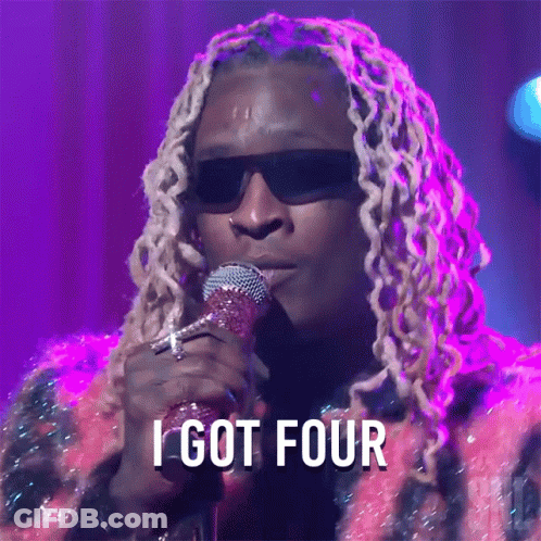 A Man Singing Into A Microphone With The Words " I Got Four " Above Him GIF