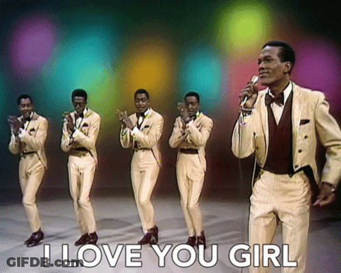 A Man Singing Into A Microphone With The Words " I Love You Girl " Behind Him GIF