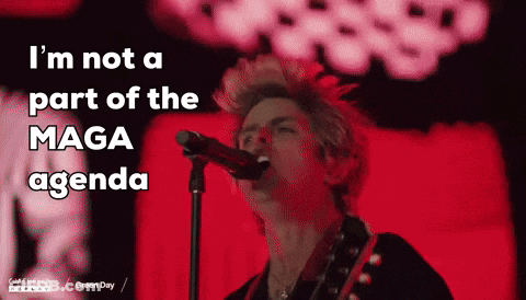 A Man Singing Into A Microphone With The Words " I 'M Not A Part Of The Maga Agenda " Above Him GIF