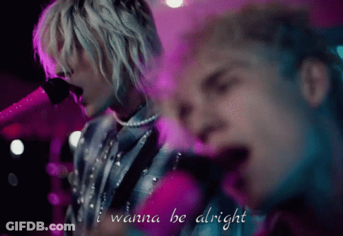 A Man Singing Into A Microphone With The Words I Wanna Be Alright Above Him GIF
