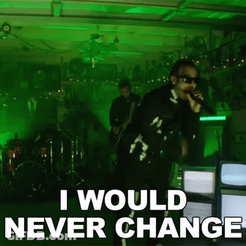 A Man Singing Into A Microphone With The Words " I Would Never Change " Below Him GIF