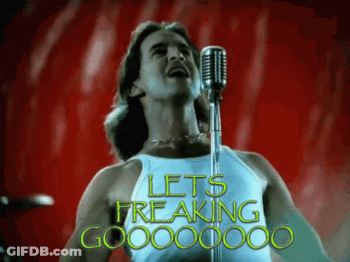 A Man Singing Into A Microphone With The Words Let 'S Freaking Go Written In Green GIF