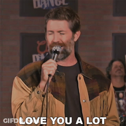 A Man Singing Into A Microphone With The Words Love You A Lot On The Bottom GIF
