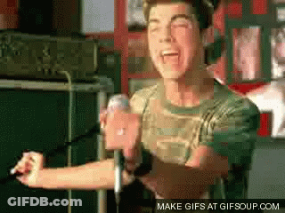 A Man Singing Into A Microphone With The Words Make Gifs At Gifsoup.com Below GIF