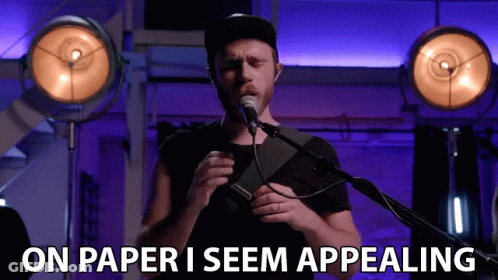 Man Singing Into Microphone With On Paper I Seem Appealing GIF