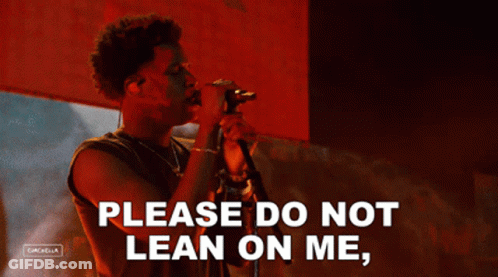 A Man Singing Into A Microphone With The Words Please Do Not Lean On Me On The Bottom GIF