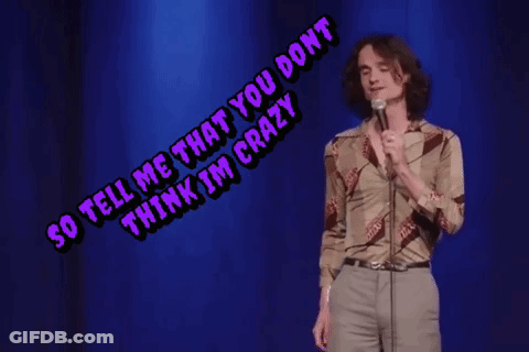 A Man Singing Into A Microphone With The Words So Tell Me That You Don T Think I 'M Crazy Above Him GIF