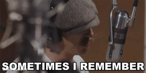 A Man Singing Into A Microphone With The Words " Sometimes I Remember " Below Him GIF