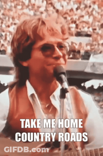 A Man Singing Into A Microphone With The Words Take Me Home Country Roads GIF