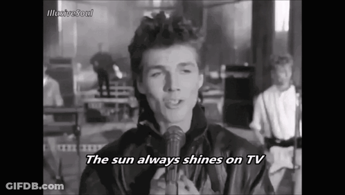 A Man Singing Into A Microphone With The Words The Sun Always Shines On Tv GIF