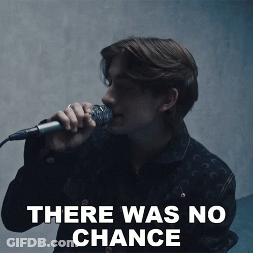 A Man Singing Into A Microphone With The Words There Was No Chance Behind Him GIF