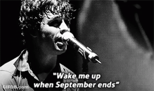 A Man Singing Into A Microphone With The Words " Wake Me Up When September Ends " On The Bottom GIF