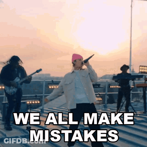A Man Singing Into A Microphone With The Words " We All Make Mistakes " Above Him GIF