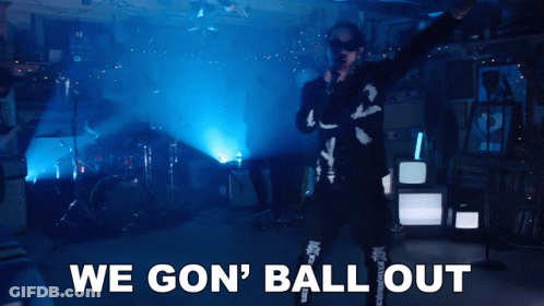 A Man Singing Into A Microphone With The Words " We Gon ' Ball Out " Behind Him GIF