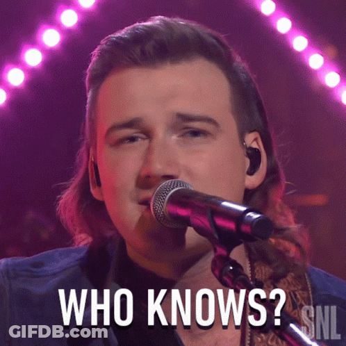 A Man Singing Into A Microphone With The Words Who Knows Above Him GIF