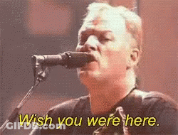 A Man Singing Into A Microphone With The Words Wish You Were Here Above Him GIF