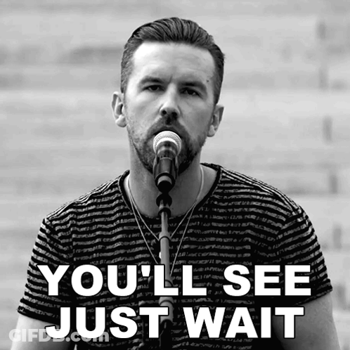 A Man Singing Into A Microphone With The Words You 'Ll See Just Wait Behind Him GIF