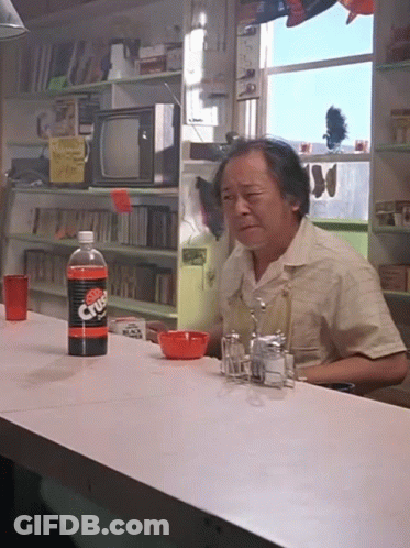 A Man Sits At A Counter With A Bottle Of Diet Dr Pepper On It GIF