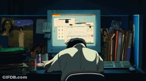 A Man Sits At A Desk In Front Of A Computer Screen That Says ' Microsoft ' GIF