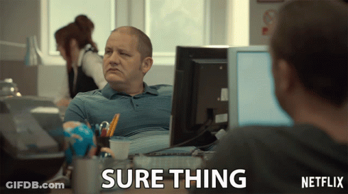 A Man Sits At A Desk In Front Of A Computer With A Netflix Logo In The Corner GIF